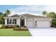 Inviting single-Gathering home with stone detailing, lush landscaping, and a two-car garage offers great curb appeal at 16030 10Th E Ave, Bradenton, FL 34212