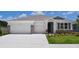 Charming single-Gathering home with a two-car garage, stone accents, and a well-manicured lawn and landscaping at 16030 10Th E Ave, Bradenton, FL 34212