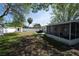 Backyard view showing patio, screened porch, and grassy area at 1779 Shore Acres Ne Blvd, St Petersburg, FL 33703