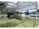 Covered playground with slides, climbing structures, and nearby pool at 1779 Shore Acres Ne Blvd, St Petersburg, FL 33703
