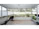 Bright screened porch with backyard view and exercise equipment at 1779 Shore Acres Ne Blvd, St Petersburg, FL 33703