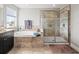 This bathroom features a soaking tub, a glass enclosed shower, and luxury finishes at 19757 Long Lake Ranch Blvd, Lutz, FL 33558
