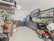 Organized garage featuring overhead storage racks, cabinets, shelving, and durable epoxy flooring at 19757 Long Lake Ranch Blvd, Lutz, FL 33558