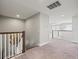 Upstairs hallway with carpet, offering a bright and open transition between living spaces at 19757 Long Lake Ranch Blvd, Lutz, FL 33558
