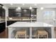 Bright kitchen showcasing granite countertops, sleek dark cabinetry, and stainless steel appliances at 19757 Long Lake Ranch Blvd, Lutz, FL 33558