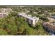 Aerial view of a condo building nestled in lush greenery, offering a tranquil setting at 206 Tarpon Pt, Tarpon Springs, FL 34689