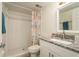 Clean bathroom with granite vanity and tiled shower at 206 Tarpon Pt, Tarpon Springs, FL 34689
