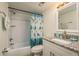 Updated bathroom with granite vanity and tiled shower/tub combo at 206 Tarpon Pt, Tarpon Springs, FL 34689