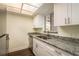 Modern kitchen with white cabinets and granite counters at 206 Tarpon Pt, Tarpon Springs, FL 34689