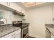 Stainless steel appliances and granite countertops in kitchen at 206 Tarpon Pt, Tarpon Springs, FL 34689