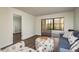 Living room with sofa, ottoman, and access to another room at 206 Tarpon Pt, Tarpon Springs, FL 34689
