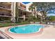 Community pool with surrounding patio furniture at 206 Tarpon Pt, Tarpon Springs, FL 34689