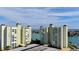 Aerial view of waterfront condo building with parking and boat slips at 400 64 Ave # 1207, St Pete Beach, FL 33706