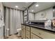 Bathroom with granite countertop, light cabinets, and a shower/tub combo at 400 64 Ave # 1207, St Pete Beach, FL 33706