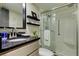 Clean bathroom with a walk-in shower and granite countertop at 400 64 Ave # 1207, St Pete Beach, FL 33706