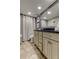 Bathroom with granite countertop, light cabinets, and a shower/tub combo at 400 64 Ave # 1207, St Pete Beach, FL 33706