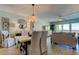 Bright dining area with table and chairs, offering a view of the kitchen at 400 64 Ave # 1207, St Pete Beach, FL 33706