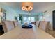 Bright dining room with light-colored table and chairs, offering a spacious and elegant ambiance at 400 64 Ave # 1207, St Pete Beach, FL 33706