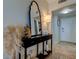 Inviting entryway with a console table and mirror, creating a welcoming atmosphere at 400 64 Ave # 1207, St Pete Beach, FL 33706