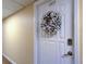 Apartment front door with keyless entry and decorative wreath at 400 64 Ave # 1207, St Pete Beach, FL 33706
