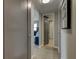 Clean and bright hallway with light gray walls and wood-look flooring at 400 64 Ave # 1207, St Pete Beach, FL 33706