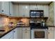 Modern kitchen with stainless steel appliances and granite countertops at 400 64 Ave # 1207, St Pete Beach, FL 33706