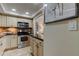 Modern kitchen with stainless steel appliances and granite countertops at 400 64 Ave # 1207, St Pete Beach, FL 33706
