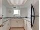 Small kitchenette with white cabinets and granite countertops at 400 64 Ave # 1207, St Pete Beach, FL 33706