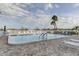 Community pool with lounge chairs and waterfront views at 400 64 Ave # 1207, St Pete Beach, FL 33706