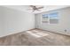 Spacious bedroom with neutral carpeting and a large window at 7430 Buchanan Dr, Port Richey, FL 34668