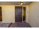 Inviting front entrance with a dark wood door and patterned tile flooring at 7430 Buchanan Dr, Port Richey, FL 34668