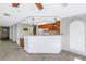 Kitchen features wood cabinets, white appliances, and a breakfast bar at 7430 Buchanan Dr, Port Richey, FL 34668