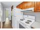 Kitchen with white appliances and wood cabinets at 7430 Buchanan Dr, Port Richey, FL 34668