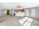 Open concept kitchen and living area with wood cabinets and breakfast bar at 7430 Buchanan Dr, Port Richey, FL 34668