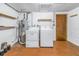 Basement laundry room with washer, dryer, and shelving at 7430 Buchanan Dr, Port Richey, FL 34668