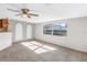 Bright living room with neutral carpeting and large window at 7430 Buchanan Dr, Port Richey, FL 34668