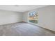 Bright living room with large window and carpeting at 7430 Buchanan Dr, Port Richey, FL 34668