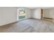 Living room with large window, carpet, and neutral walls at 7430 Buchanan Dr, Port Richey, FL 34668