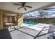 Screened-in pool area with ceiling fan at 7430 Buchanan Dr, Port Richey, FL 34668