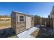 Wooden storage shed with double windows and a single door at 7430 Buchanan Dr, Port Richey, FL 34668