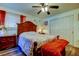 Cozy bedroom with a wooden bed frame and red blanket at 762 Barbara St, Palm Harbor, FL 34684