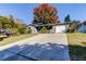 Single story home with gray exterior and a white garage door at 762 Barbara St, Palm Harbor, FL 34684