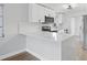 Modern kitchen with white cabinets, quartz countertops and an island breakfast bar at 1000 49Th N St # 214, St Petersburg, FL 33710
