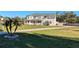 Two-story house with a large yard, driveway, and palm tree at 11305 Sweet Bay Ct, Riverview, FL 33569