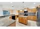 Kitchen with an island, granite countertops, and wood cabinets at 11305 Sweet Bay Ct, Riverview, FL 33569