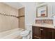 Updated bathroom with a tub, toilet and vanity at 13250 Ridge Rd # 2-1, Largo, FL 33778