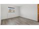 Cozy bedroom with light-grey wood-look flooring and a window for natural light at 13250 Ridge Rd # 2-1, Largo, FL 33778