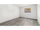 Bedroom with light-grey wood-look flooring, natural light, and closet at 13250 Ridge Rd # 2-1, Largo, FL 33778