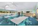 Community room with tables, chairs, and large windows at 13250 Ridge Rd # 2-1, Largo, FL 33778
