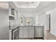 Updated kitchen showcasing stainless steel appliances, granite counters, and ample cabinet space at 13250 Ridge Rd # 2-1, Largo, FL 33778